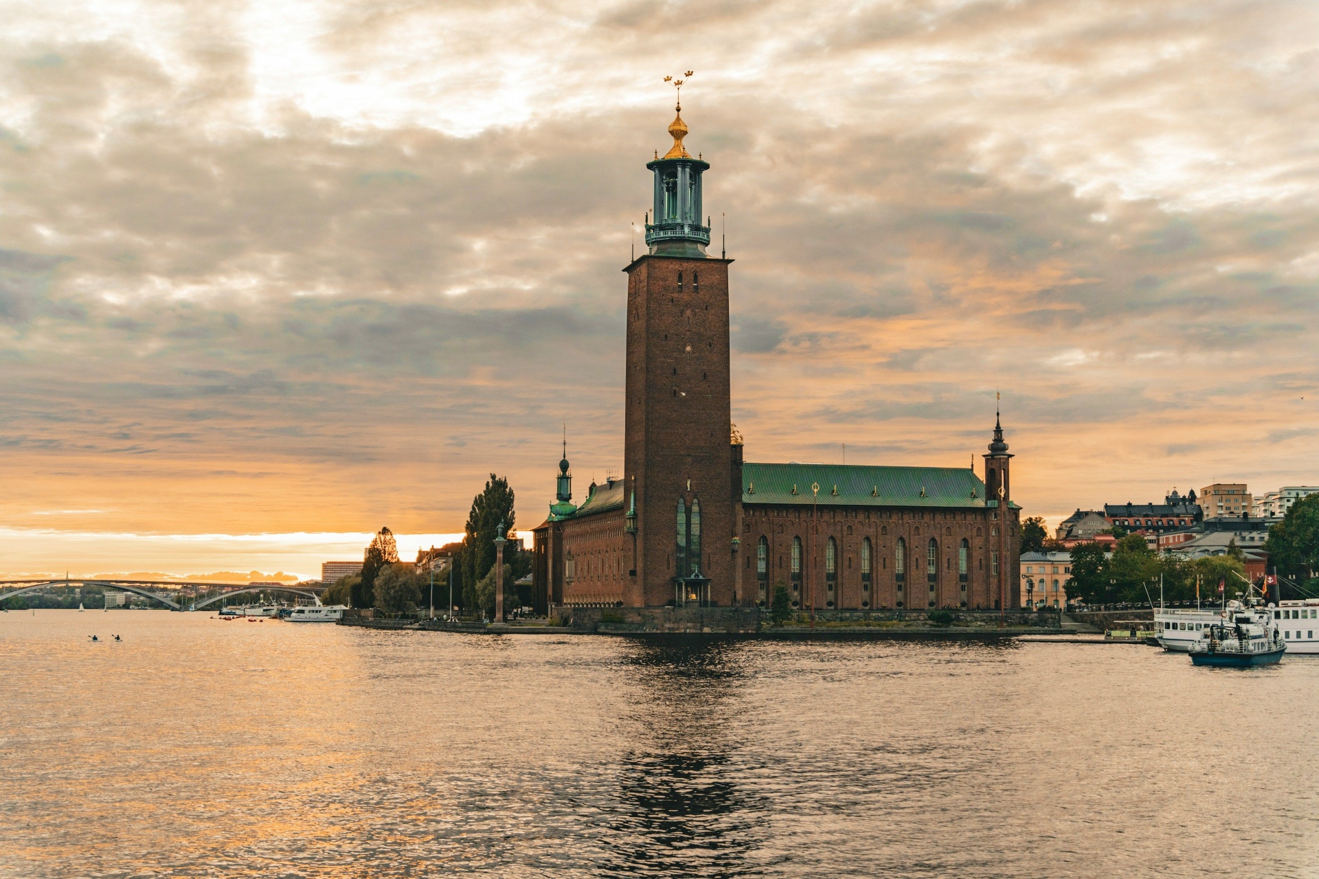 Stockholm City Hall at golden hour over the water