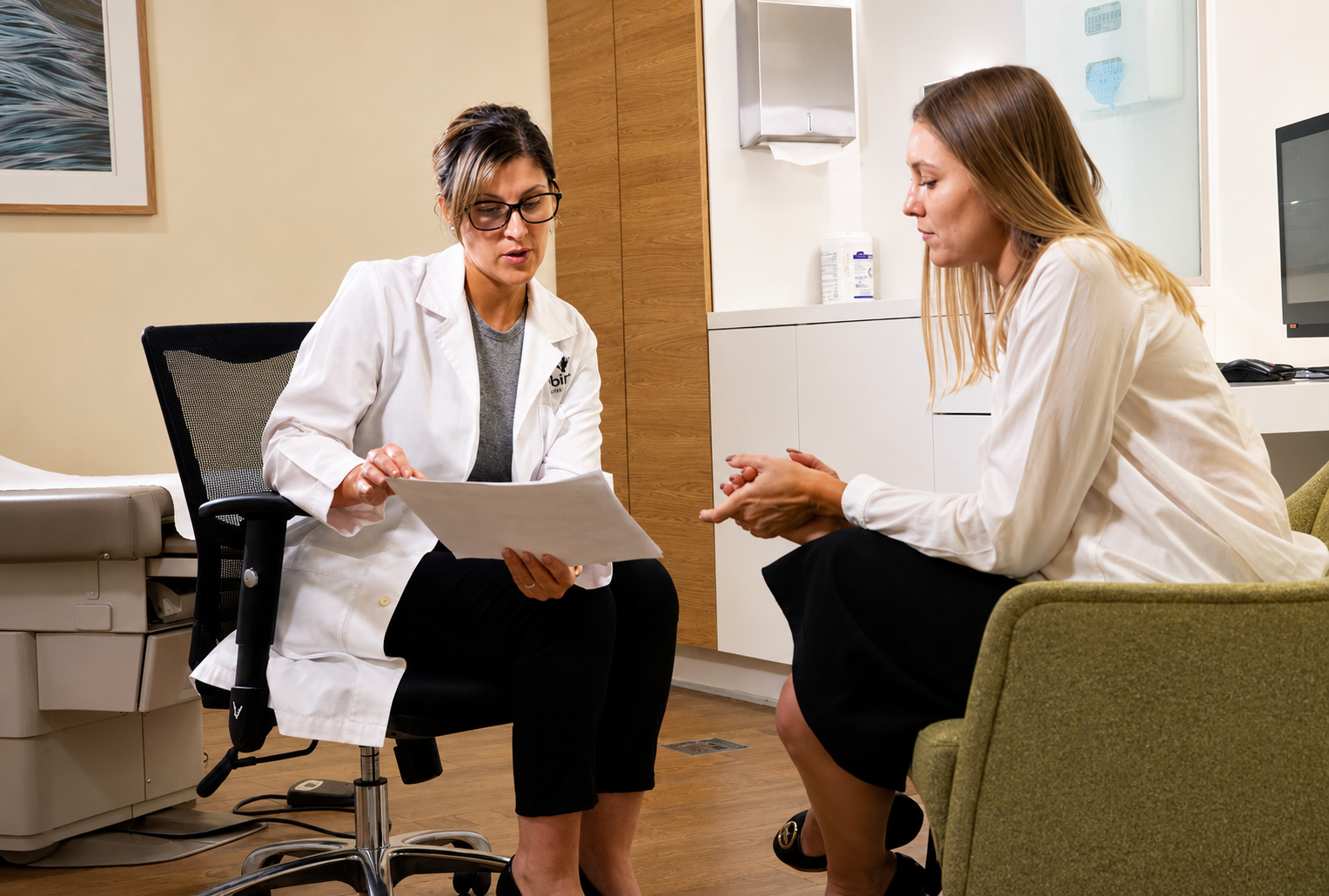 Physician consulting with a patient in a sunlit Dubai clinic room